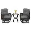 The DirectDeals 3-Piece Patio Swivel Rocker Set with Glass Side Table includes two dark wicker swivel chairs with gray cushions and a round glass table, styled with a vase of yellow flowers, teacups, and a magazine.