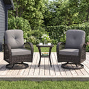 The DirectDeals 3-Piece Patio Swivel Rocker Set with Glass Side Table features two cushioned chairs and a table—ideal outdoor seating on a wooden deck, surrounded by lush trees, bushes, and a fence.