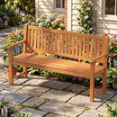 The DirectDeals 3-Seater Wooden Garden Bench with Backrest, 59 Inch sits on a stone patio among blooming flowers and greenery, providing inviting outdoor seating by a house with beige siding and windows.