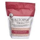 A resealable 3lb bag of SALTOPIA Pink Himalayan Fine Salt features a clear window to display the mineral-rich pink salt inside. The fine grain sea salt is packaged under the SALTOPIA Infused Sea Salts brand.