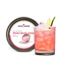A glass of pink cocktail with ice, garnished with a lime wedge and a salt rim, sits next to a tin labeled The Spice Lab Pink Himalayan Salt Cocktail Rimmer by The Spice Lab. This vibrant rimmer adds an elegant touch to margaritas and other favorite cocktails.