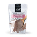 A 1 lb bag of The Spice Lab India Black Kala Namak Salt by The Spice Lab, a prized Himalayan black salt highly regarded in South Asian cuisine, accompanied by a wooden spoon filled with the salt and front packaging that features certifications and detailed product information.