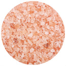 Close-up view of The Spice Lab Himalayan Pink Salt Coarse Grain crystals—showcasing their varying sizes and shades of pink, white, and orange—arranged within a circular frame on a white background. Perfect for refilling the included grinder in The Spice Lab’s 3-Pack set.