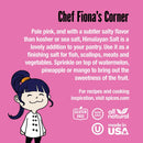 A cartoon chef with dark hair stands smiling on a pink background. The text highlights the versatility and delicious flavor of The Spice Lab Himalayan Pink Salt Coarse Grain, recommending its use in recipes with a salt grinder or as a coarse finishing salt. Logos at the bottom indicate that this product from The Spice Lab is gluten-free, non-GMO, all-natural, certified kosher, and made in the USA.