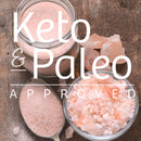 Three jars from The Spice Lab Himalayan Pink Salt Coarse Grain with Grinder 3-Pack sit on a wooden surface, accompanied by a spoon and large salt crystals. Text reads “Keto & Paleo Approved.”.