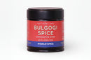 A 2.26 oz (64g) jar of World Spice Bulgogi Spice, a handcrafted Korean blend by World Spice, featuring red and blue accents on the label. The blend highlights flavors of gochugaru and sesame, with "Heat • Umami • Tangy" noted on the label and "World Spice" displayed at the bottom.