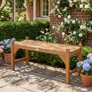 The DirectDeals 40-Inch Outdoor Bench with Contoured Seat - Set of 2 sits on a stone patio, surrounded by potted hydrangeas, white roses climbing a brick wall, and lush green hedges.