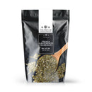 A black and white resealable pouch labeled “The Spice Lab French Lavender + Rosemary Seasoning” is shown, with a wooden spoon holding dried herbs placed in front. This sugar-free blend from The Spice Lab offers a savory mix of aromatic herbs, perfect for enhancing your favorite dishes. Net weight: 2 lb—ideal for anyone seeking flavorful herb seasoning.