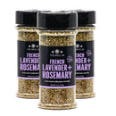 Three bottles of The Spice Lab French Lavender + Rosemary Seasoning, each containing 4 oz, are shown with black lids and purple labels on a white background. This sugar-free blend by The Spice Lab combines savory French lavender and rosemary flavors for an aromatic boost to your favorite dishes.
