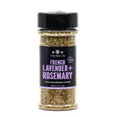 A clear spice jar from The Spice Lab, labeled French Lavender + Rosemary, features a black lid and purple label and is filled with a blend of dried herbs—The Spice Lab French Lavender + Rosemary Seasoning is the perfect sugar-free way to add savory flavor to your meals.
