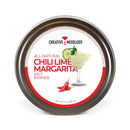 A round tin labeled The Spice Lab Chili Lime Margarita Salt Cocktail Rimmer, ideal for rimming cocktail glasses, features an image of a margarita glass, lime, and red chili peppers. The white and red label showcases The Spice Lab branding. Net weight: 3.5 oz.