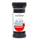 A plastic jar labeled The Spice Lab Black Obsidian Salt Cocktail Rimmer, featuring an image of a cocktail glass rimmed with Black Obsidian Salt and garnished with a strawberry—an ideal cocktail rimmer from The Spice Lab for elevating your margaritas or signature drinks.