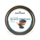 A tin labeled The Spice Lab Black Obsidian Salt Cocktail Rimmer, featuring a small bowl and wooden scoop filled with dramatic black obsidian salt on the front—perfect as a striking margarita salt or cocktail rimmer for your favorite drinks.