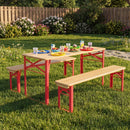 The 43.5 Inch Folding Kids Picnic Table & Bench Set No Assembly Wooden Toddler Table by DirectDeals, featuring red legs and benches, is set on grass with colorful plates, cups, food, flowers, bushes, and a wooden fence.