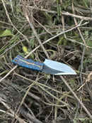 The Texan Knives Hunters Knife features a 9" D2 steel blade and an epoxy pine cone resin handle, and comes with a leather sheath—perfect for hunters seeking style and durability.