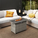Outdoor patio with two sectionals, a yellow pillow, a pumpkin, hanging candles, and the DirectDeals 44.5 Inch Propane Fire Pit Table Rattan Gas 2-in-1 with Stainless Steel Burner for cozy heat. Plants and a woven rug complete the scene.