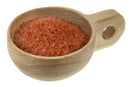 A wooden cup with a handle holds fine-grain Hawaiian Red Alaea Sea Salt by The Spice Lab, displayed on a white background.