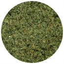 A close-up, top-down view of The Spice Lab Whole Leaf Cilantro by The Spice Lab, revealing small, flat, green herb pieces inside a circular frame—similar in appearance to dried cilantro leaves often found in bulk cilantro or whole leaf cilantro varieties.