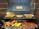 An open pellet grill equipped with a Pimp My Grill® Gen2 Slide-Out Rack System holding roasted chicken, corn on the cob, racks of ribs, casserole dishes, and a pie, showcasing the smoker’s cooking space.