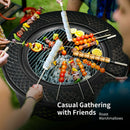 Friends gather around the Outdoor Fire Pit with BBQ Grill and High-temp Resistance Finish by DirectDeals, roasting marshmallows, veggies, and fruit. Casual Gathering with Friends. Roast Marshmallows.