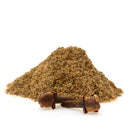 A small pile of The Spice Lab Ground Cloves with two whole clove buds in front of it on a white background, perfect for adding warmth and depth to your favorite curry seasoning or for stocking up on essential bulk spices from The Spice Lab.