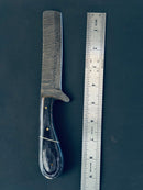 The Texan Knives Handmade Damascus Steel Calf Cutter Knife features a 5" blade and pakkawood handle, seen here beside a metal ruler on a dark surface, showing the knife to be about 8 inches long in total.