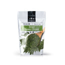 A white package labeled The Spice Lab Green Chives features a wooden spoon filled with dried chives. Ideal for French cuisine and versatile herb blends, the packaging displays a net weight of 4 oz (113g) and is branded by The Spice Lab.