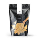 A black resealable bag labeled The Spice Lab Minced Garlic 1 lb Bulk Foodservice Spice displays an image of a wooden spoon scooping dried minced garlic pieces, making it a convenient choice for those looking to purchase bulk garlic for their kitchen. The bag features The Spice Lab logo and indicates a net weight of 1 lb.