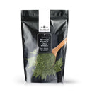 Packaged in a black resealable pouch, The Spice Lab Dill Weed Whole features a vibrant image of dried dill spilling out alongside a wooden spoon scooping up the herb. Ideal for bulk foodservice use, this 4 oz product by The Spice Lab contains premium whole dill weed.