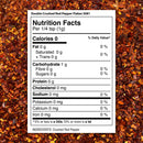 A nutrition label for The Spice Lab Double Crushed Red Pepper Flakes lies on a background of finely crushed pepper flakes. The label shows 0 calories, 1g carbohydrate, 0g fat, 0g protein, and 0mg sodium per 1/4 tsp. With ingredients listed simply as crushed red pepper, these double crushed flakes from The Spice Lab provide balanced heat to any dish.