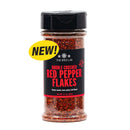 A spice jar labeled The Spice Lab Double Crushed Red Pepper Flakes, featuring a yellow “NEW!” sticker on the side. The jar is topped with a black lid and contains finely crushed pepper flakes from The Spice Lab, delivering balanced heat for your favorite dishes.