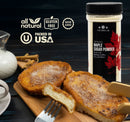 Two slices of French toast topped with The Spice Lab Maple Sugar Powder on a wooden board, next to a spice container and wooden utensils. Icons above highlight that this all-natural, gluten-free product is proudly packed in the USA.