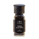 A clear grinder from The Spice Lab, filled with whole Tellicherry peppercorns and labeled “The Spice Lab Premium Black Pepper Grinder,” Net Wt. 3.2 oz. (90g), features a black cap and label—making it perfect for adding freshly ground pepper to your favorite recipes.