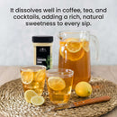Two glasses and a pitcher of iced tea with lemon slices sit on a woven mat. Nearby, a jar of The Spice Lab Turbinado Sugar from The Spice Lab—prized for being less processed and perfect for sweetening drinks—is placed alongside a sliced lemon and a wooden-handled knife. Text above highlights the sugar’s qualities.