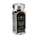 A glass jar with a metal lid holds whole Indian black peppercorns. The label reads “The Spice Lab Special Extra Bold Indian Black Peppercorns,” highlighting robust peppercorns renowned for their rich flavor and aroma.