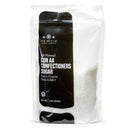 A clear resealable bag labeled The Spice Lab Sanding Con AA Sugar, containing extra coarse white sugar granules, perfect for decorative baking and ideal as sanding sugar or cupcake sprinkles, non-GMO, net weight 1 lb.