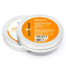 Two round silver tins with orange labels contain The Spice Lab Zesty Orange Sugar Cocktail Rimmer by The Spice Lab. One tin is closed while the other is partially open, revealing both the packaging and vibrant contents of this orange cocktail rimming sugar—an ideal citrus garnish or margarita rimmer for your next celebration.
