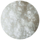 Close-up view of coarse, flaky white The Spice Lab Hudson Valley New York Premium Gourmet Salt crystals scattered within a circular frame, highlighting their rough, jagged texture and translucent appearance.
