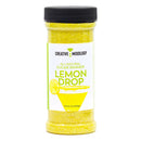 A clear plastic jar of The Spice Lab Lemon Drop Sugar Cocktail Rimmer, featuring vibrant yellow sugar inside, a black lid, and a label with a lemon wedge and yellow cocktail glass—perfect for rimming martini or cocktail glasses to create the ultimate lemon drop experience.