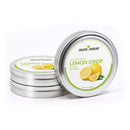 Four round metal tins of The Spice Lab Lemon Drop Sugar Cocktail Rimmer are displayed, perfect for elevating your citrus cocktails. The front tin is open to reveal a label featuring bright lemons, while three more tins from The Spice Lab are stacked neatly behind—an ideal cocktail rimmer set for any bar cart.