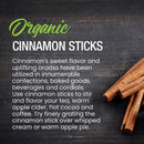 The Spice Lab Organic Cinnamon Sticks rest on a dark wooden surface, accompanied by text highlighting their rich flavor and captivating aromatics. Perfect for infusing drinks like chai or mulled wine, these cinnamon sticks from The Spice Lab also add delightful warmth to a wide variety of desserts.