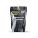 A standing black resealable pouch labeled The Spice Lab Organic Black Tellicherry Peppercorns Whole, featuring images of whole peppercorns and certification icons for non-GMO, USDA Organic, and vegan.