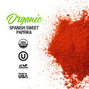 The Spice Lab Organic Spanish Sweet Paprika powder is sprinkled on a white background. Text on the left side highlights USDA Organic, kosher, all natural, and Packed in USA certifications. Perfect for BBQ rubs, this Sweet Paprika Pimenton from The Spice Lab adds vibrant color and rich flavor to your favorite dishes.