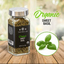A glass jar labeled The Spice Lab Organic Sweet Basil rests on a wooden table, ideal for infusing Italian-inspired dishes with fresh, aromatic flavor. Next to it, a circular inset displays vibrant basil leaves. Above, the words The Spice Lab Organic Sweet Basil are written in green and black text.