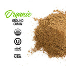 A pile of The Spice Lab Organic Ground Cumin beside text and icons: USDA Organic, Kosher, All Natural, and Packed in USA on a white background—perfect for adding warm flavor to curries or your favorite BBQ rubs.