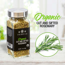 A glass jar labeled “The Spice Lab Organic Cut and Sifted Rosemary” rests on a wooden surface, accompanied by a sprig of rosemary and the text “The Spice Lab Organic Cut and Sifted Rosemary”—ideal for anyone in search of organic dried rosemary or planning to use rosemary in lamb recipes.