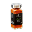 A glass jar of The Spice Lab Organic Cayenne Pepper by The Spice Lab features a metal lid and a black label, filled with vibrant red-orange ground cayenne—ideal for bringing bold heat to both Indian and Mexican cuisine.