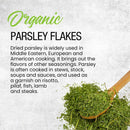A wooden spoon filled with The Spice Lab Organic Parsley Flakes rests on a textured surface beside text highlighting the culinary uses and benefits of these versatile garnishing herbs from The Spice Lab in various cuisines.
