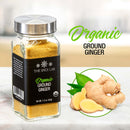 A jar labeled The Spice Lab Organic Ground Ginger—a versatile baking spice—rests on a marble surface beside fresh ginger root and slices. The text on the jar reads The Spice Lab Organic Ground Ginger in green and black, highlighting the purity of this essential ginger spice.