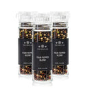 Three clear jars from The Spice Lab Four Pepper Blend with Grinder 3-Pack, each filled with a colorful mix of black, white, green, and pink peppercorns, are grouped together on a white background—perfect for refilling your favorite pepper grinder.
